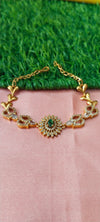 Gold bracelet with green gems stone