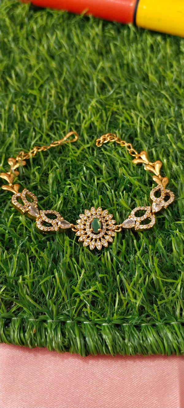 Gold bracelet with green gems stone