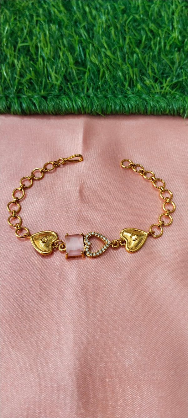 Gold Bracelet with Heart-Shaped Charms with lite pink stone