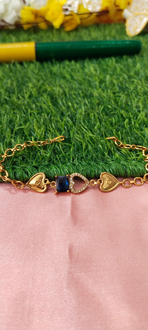 Gold Bracelet with Heart-Shaped Charms with blue pendent