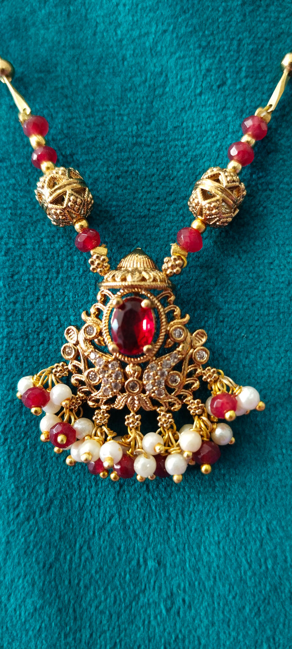 Swan pendant with golden balls and red stones no earrings