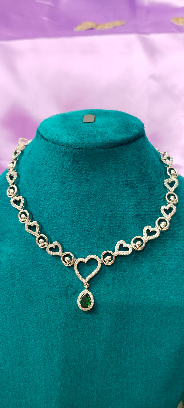 A charming heart necklace chain featuring a vibrant green pendant.