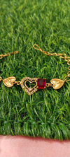 Gold Bracelet with Heart-Shaped Charms with red pendent