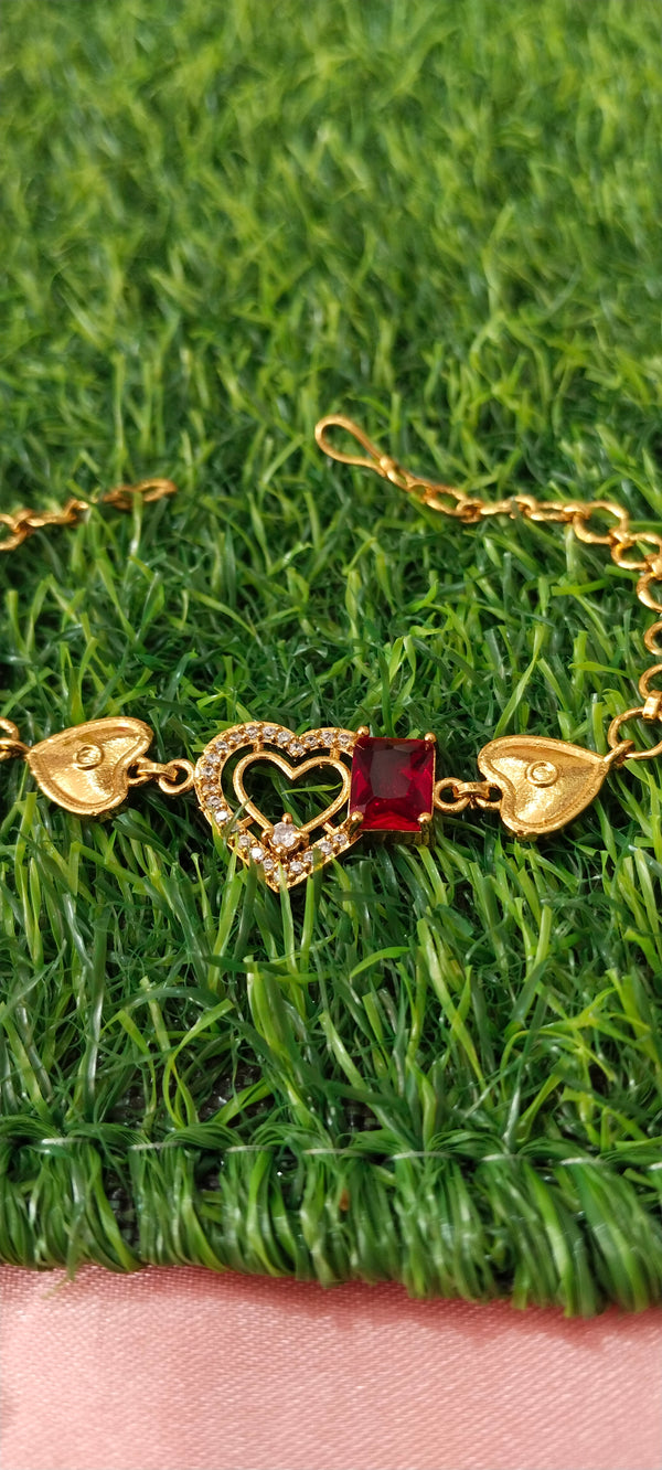 Gold Bracelet with Heart-Shaped Charms with red pendent
