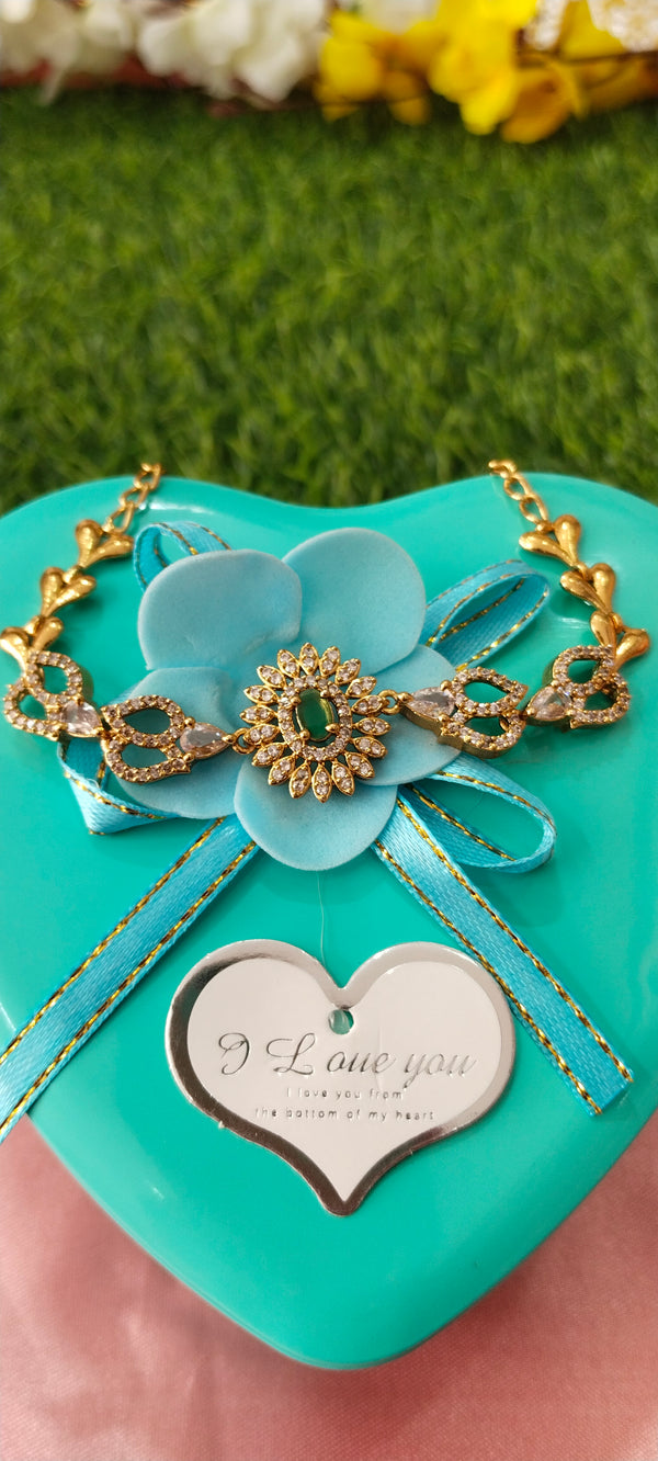 Gold bracelet with green gems stone