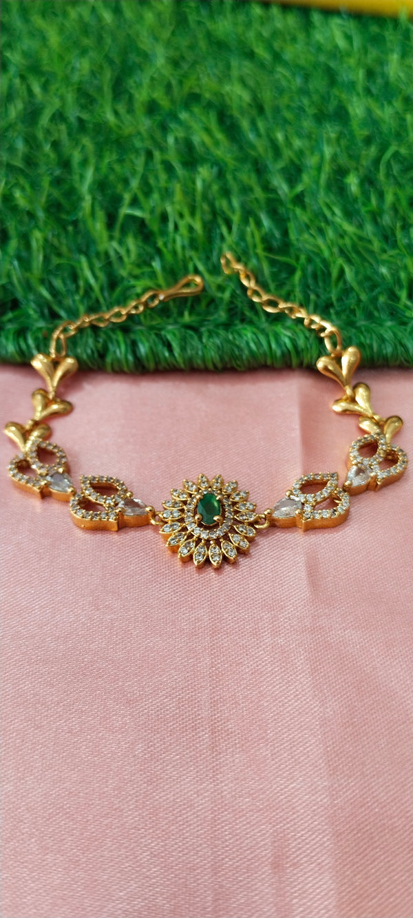 Gold bracelet with green gems stone