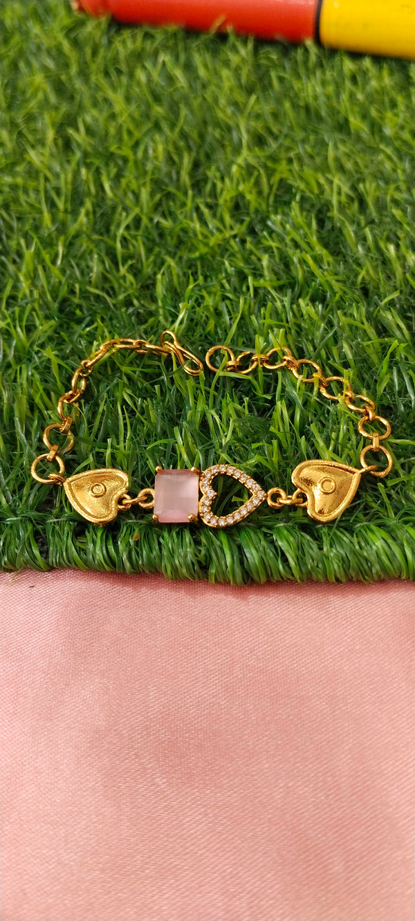 Gold Bracelet with Heart-Shaped Charms with lite pink stone